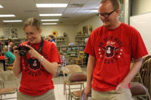 library staff take photos at an event during the 2016 summer reading program
