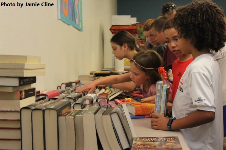 Children pick out free books provided by the Friends of the Library at the end of Summer Reading Program party. Photo by Jamie Cline.