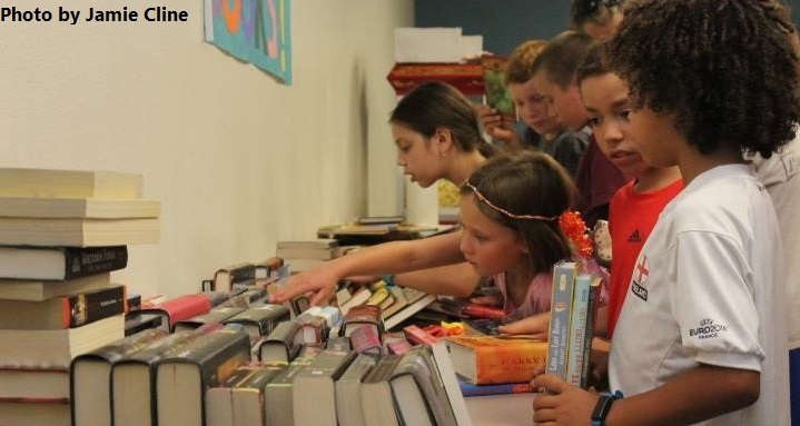 Children pick out free books provided by the Friends of the Library at the end of Summer Reading Program party. Photo by Jamie Cline.