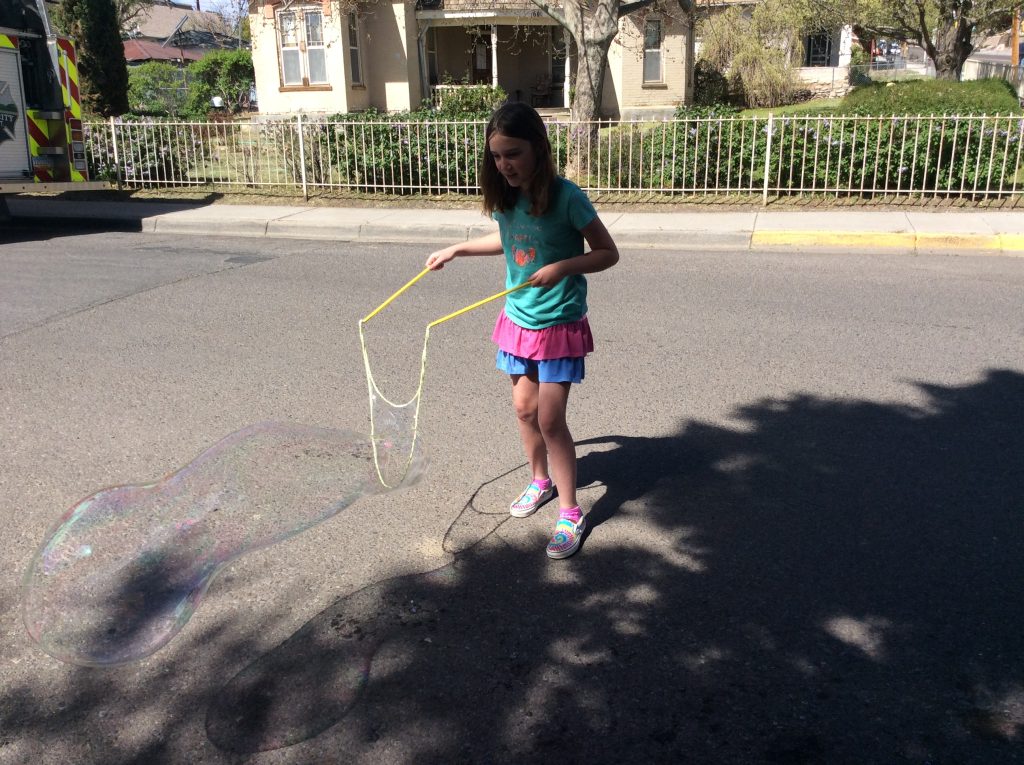 young library user making giant bubbles